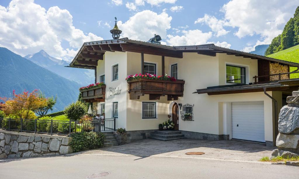 a house in the mountains with a garage at Haus Mader in Hippach