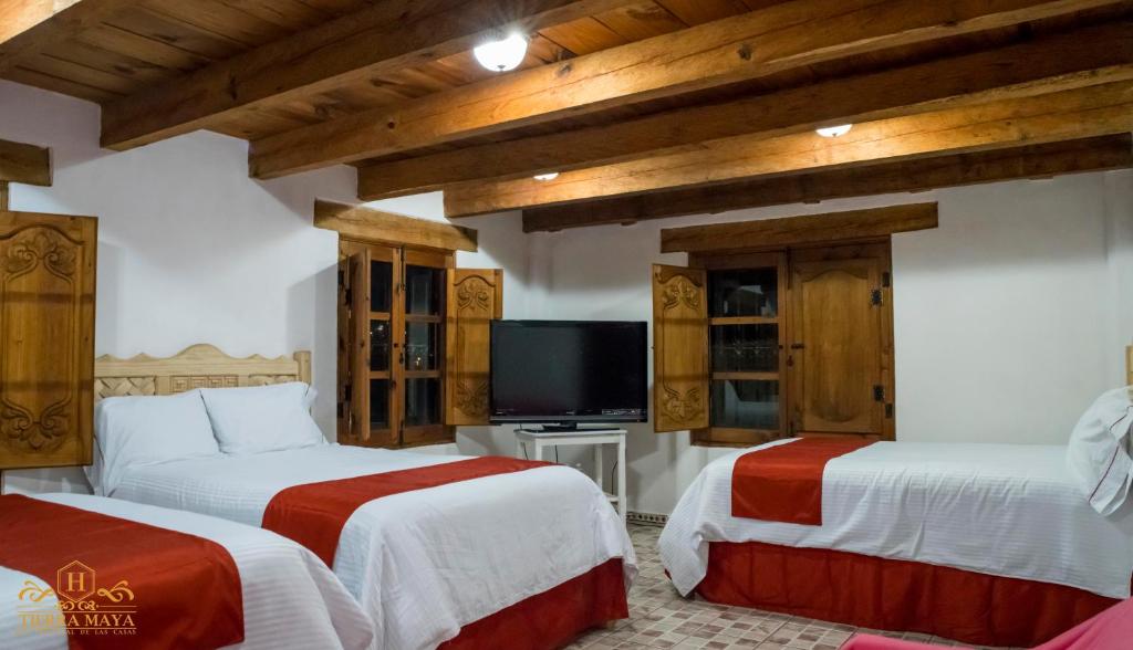 Postel nebo postele na pokoji v ubytování Hotel Tierra Maya