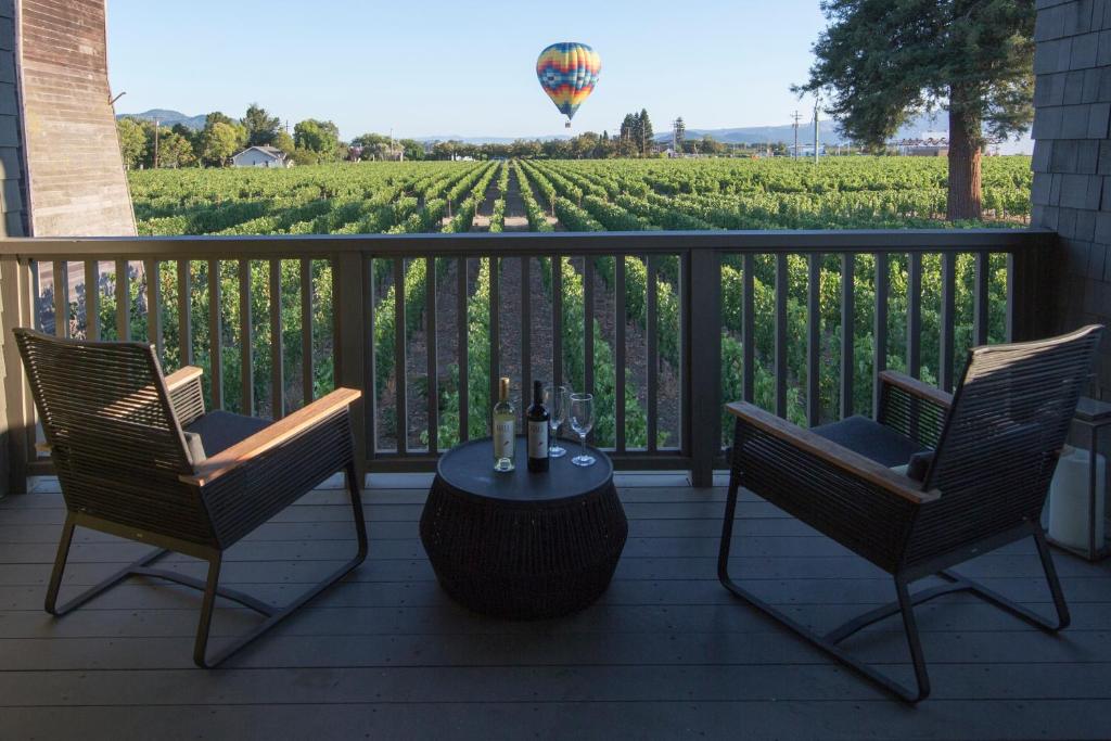 a porch with two chairs and a table with a view of a balloon at SENZA Hotel in Napa