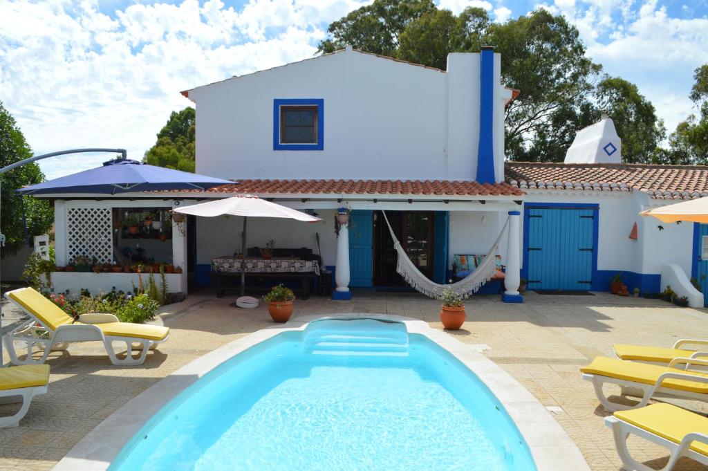 a villa with a swimming pool and a house at Monte das Silveirinhas - Casa Rural in Silveiras