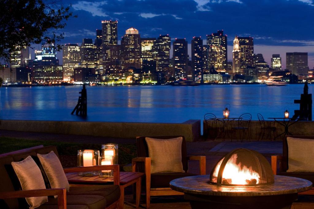 a table with a candle lit at night in front of a city at Hyatt Regency Boston Harbor in Boston