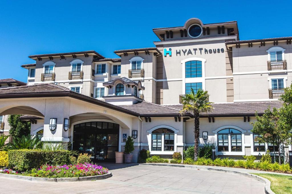 a large building with a clock on the front of it at Hyatt House San Ramon in San Ramon