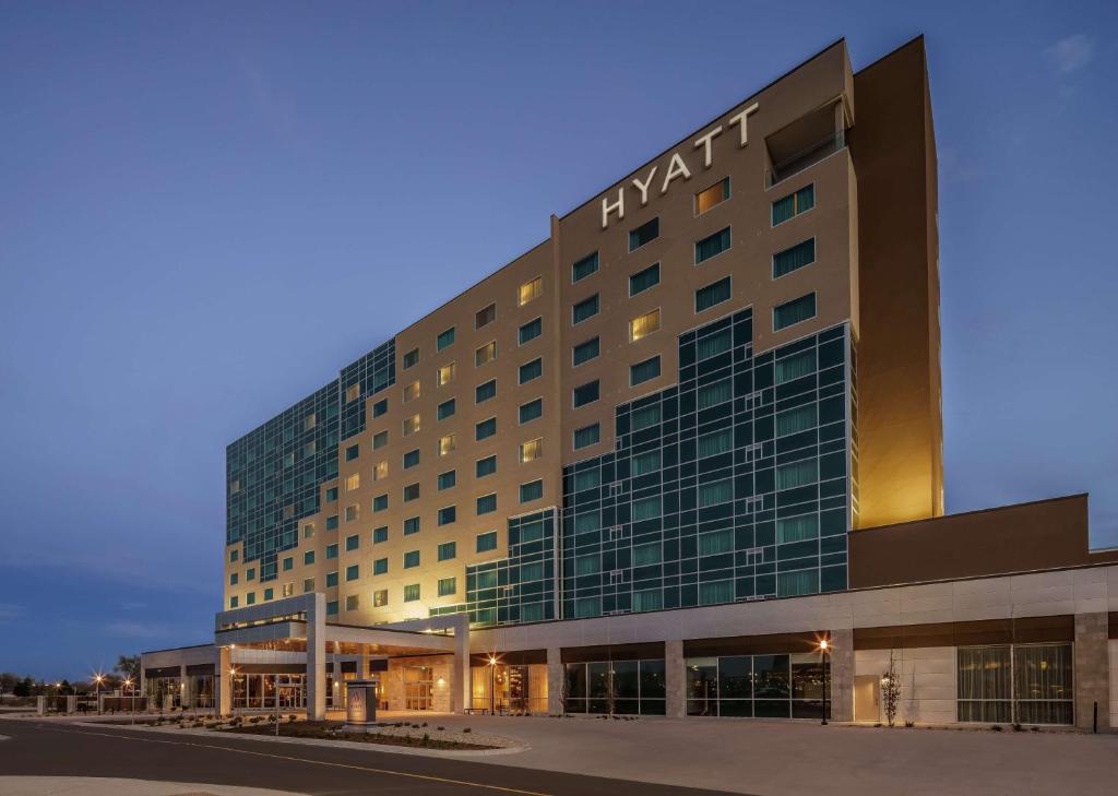 a large hotel building with a lot of windows at Hyatt Regency Aurora-Denver Conference Center in Aurora