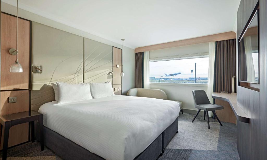 a hotel room with a large bed and a window at Hyatt Place London Heathrow Airport in Hillingdon