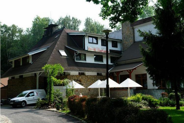 a white car parked in front of a building at Zajazd U Dudziarza in Kościan