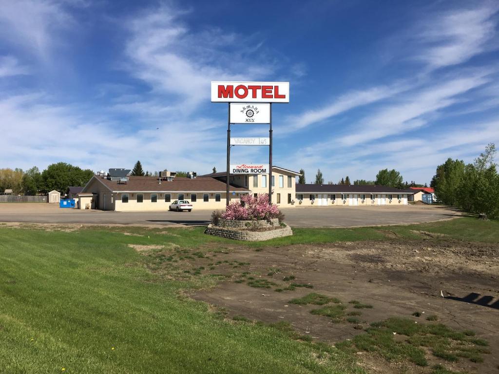 a motel sign in the middle of a parking lot at Armada Inn Motel in Unity