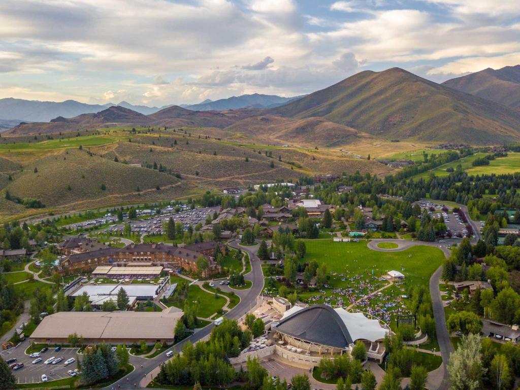 a large building with a mountain range in the distance at Sun Valley Resort in Sun Valley