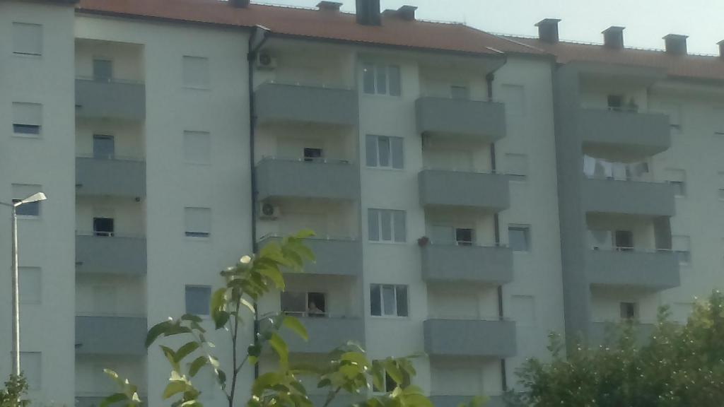 an apartment building with balconies on the side of it at Apartman Pažin in Trebinje