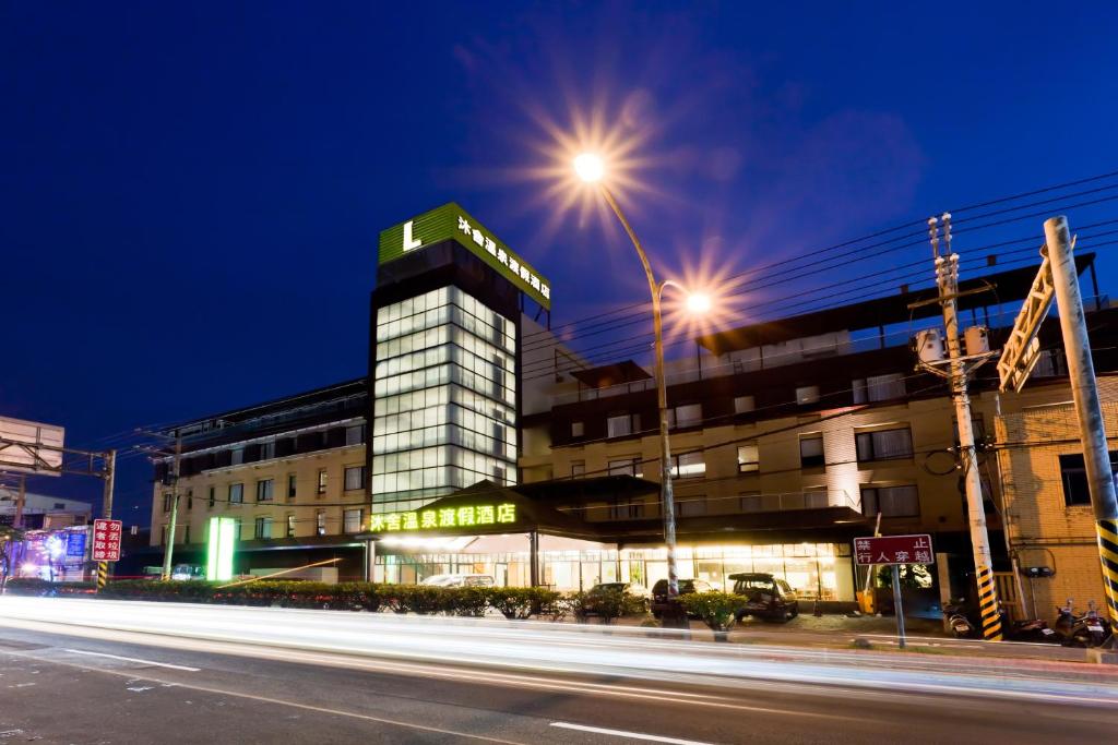 a building with a sign on top of it at night at The Loft Seaside Suites in Jinshan