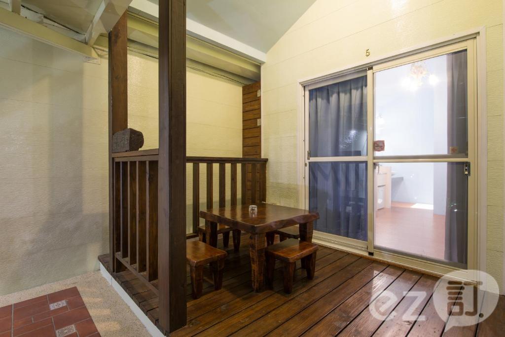 a dining room with a table and a window at Red Sun in Checheng