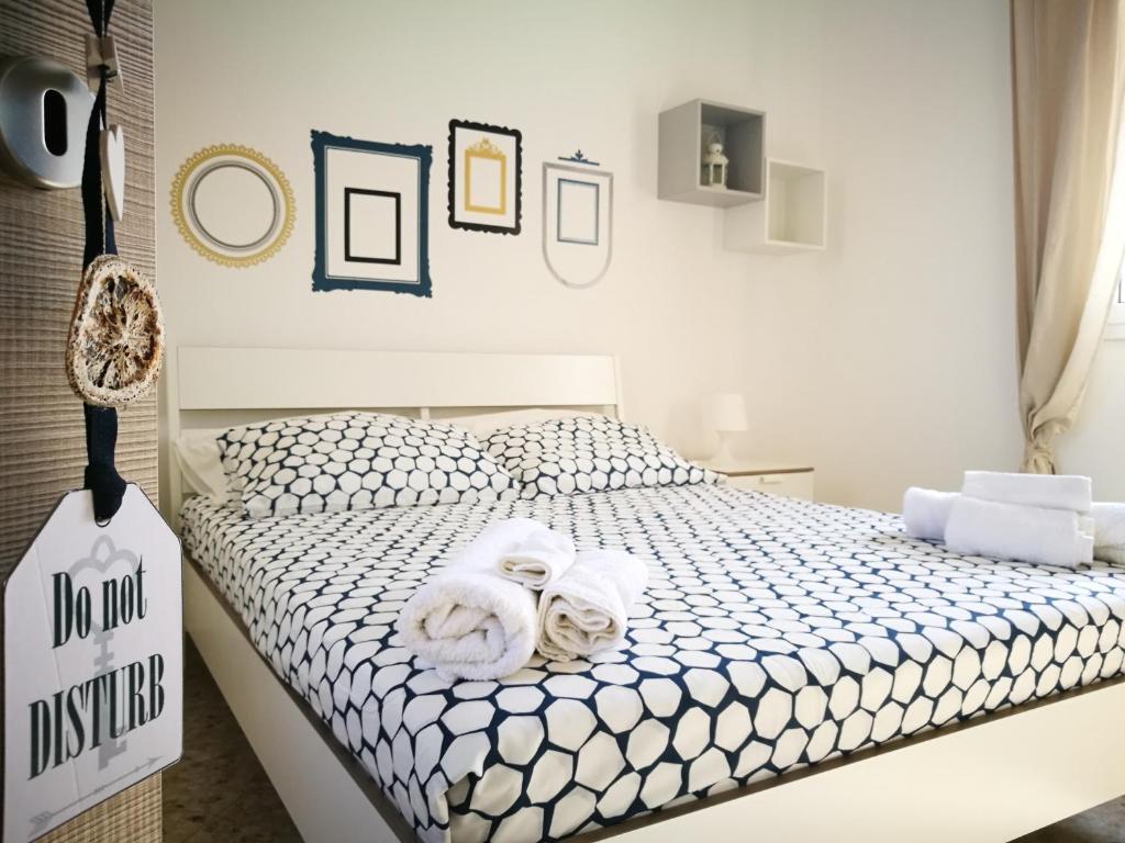 a bedroom with a bed with towels on it at Simply House in Bari in Bari
