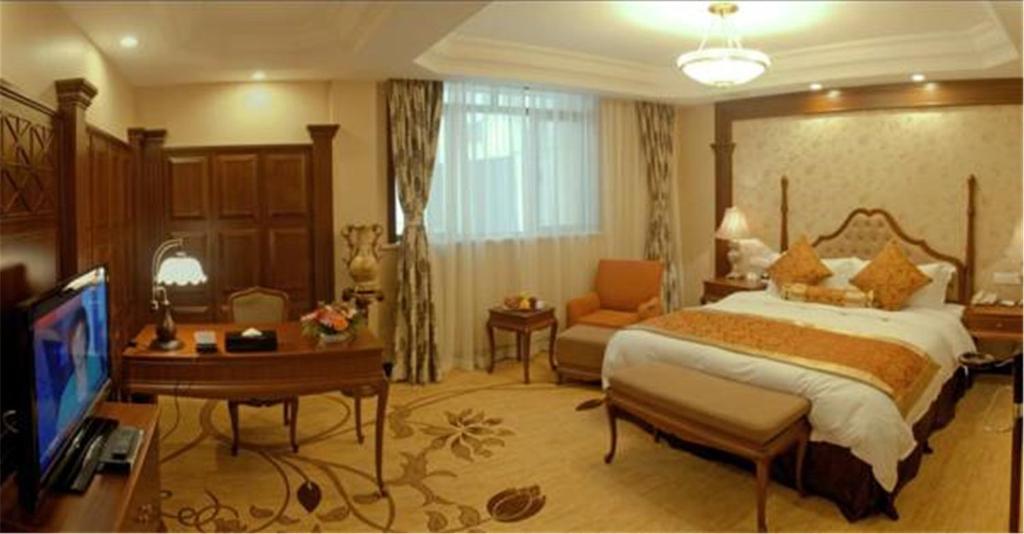 Postel nebo postele na pokoji v ubytování Jin Jiang Pacific Hotel