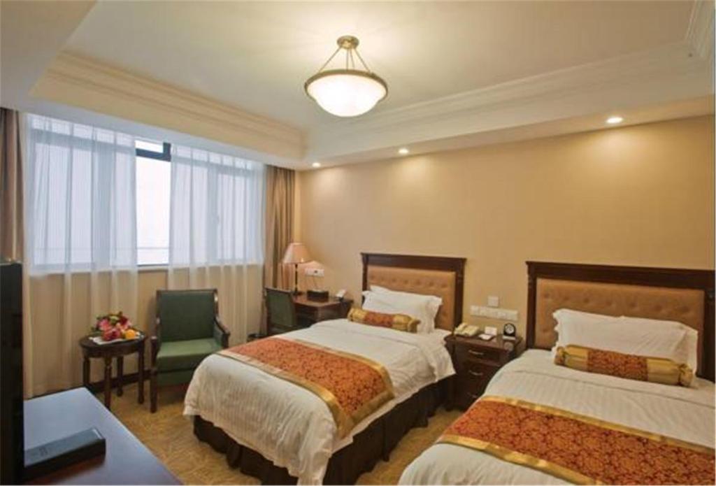 Postel nebo postele na pokoji v ubytování Jin Jiang Pacific Hotel