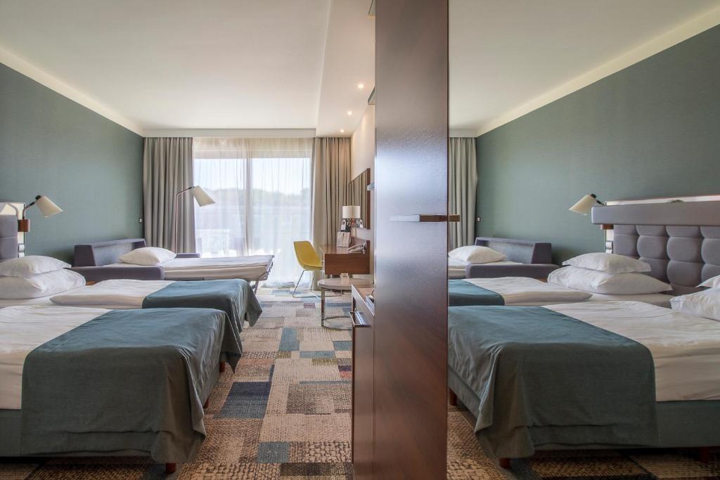 Postel nebo postele na pokoji v ubytování Hotel Aquarius SPA
