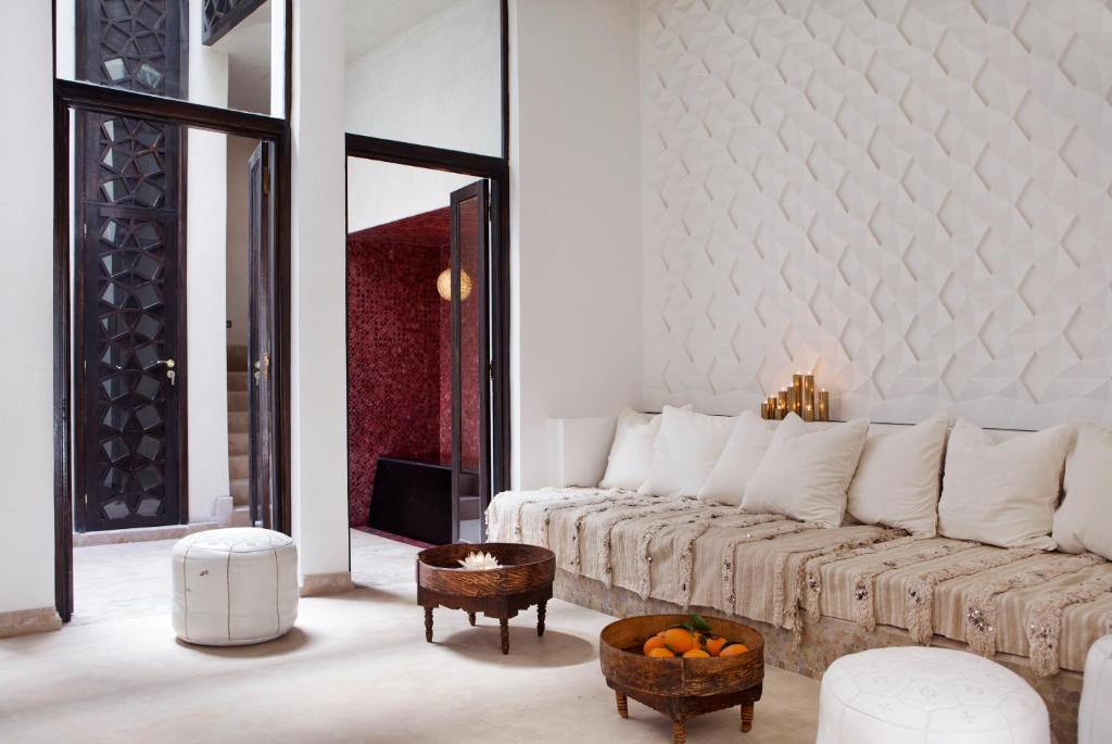 a white living room with a couch and a table at P´tit Habibi in Marrakesh