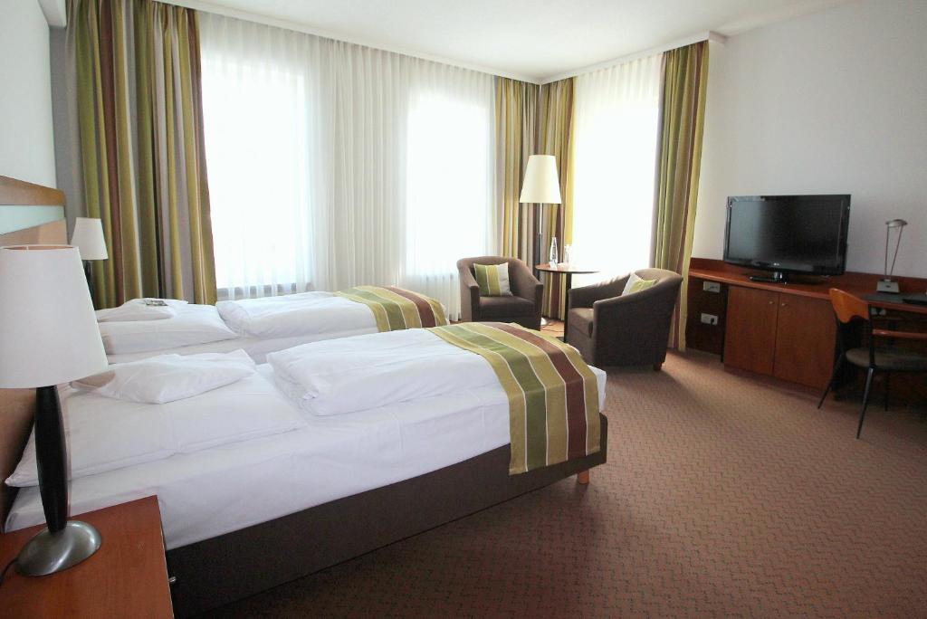 Postel nebo postele na pokoji v ubytování Hansa Apart-Hotel Regensburg