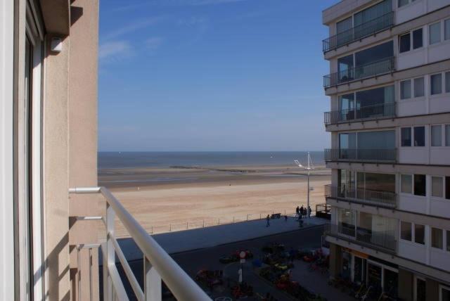 a view of the beach from a balcony of a building at Nevada in Koksijde