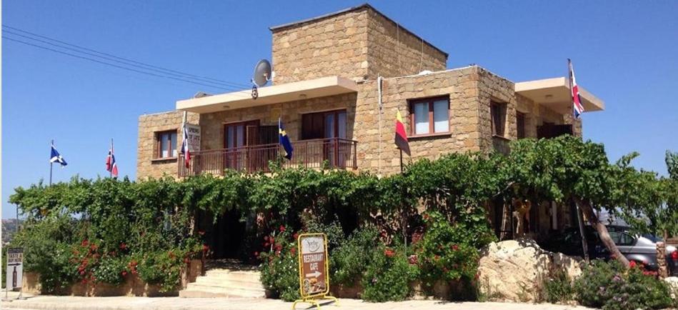 a brick house with a sign in front of it at Spring Of Life Forever in Amargeti