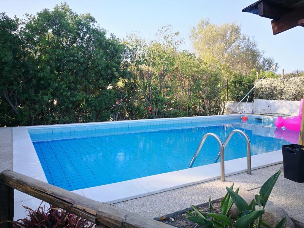 a swimming pool in a backyard with a blue at Tiny House in Cagliari