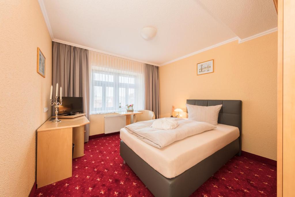 Voodi või voodid majutusasutuse Hotel Mühlhäuser Hof toas