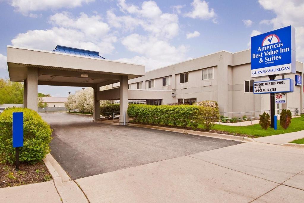 a large white building with a sign in front of it at Americas Best Value Inn Waukegan in Waukegan