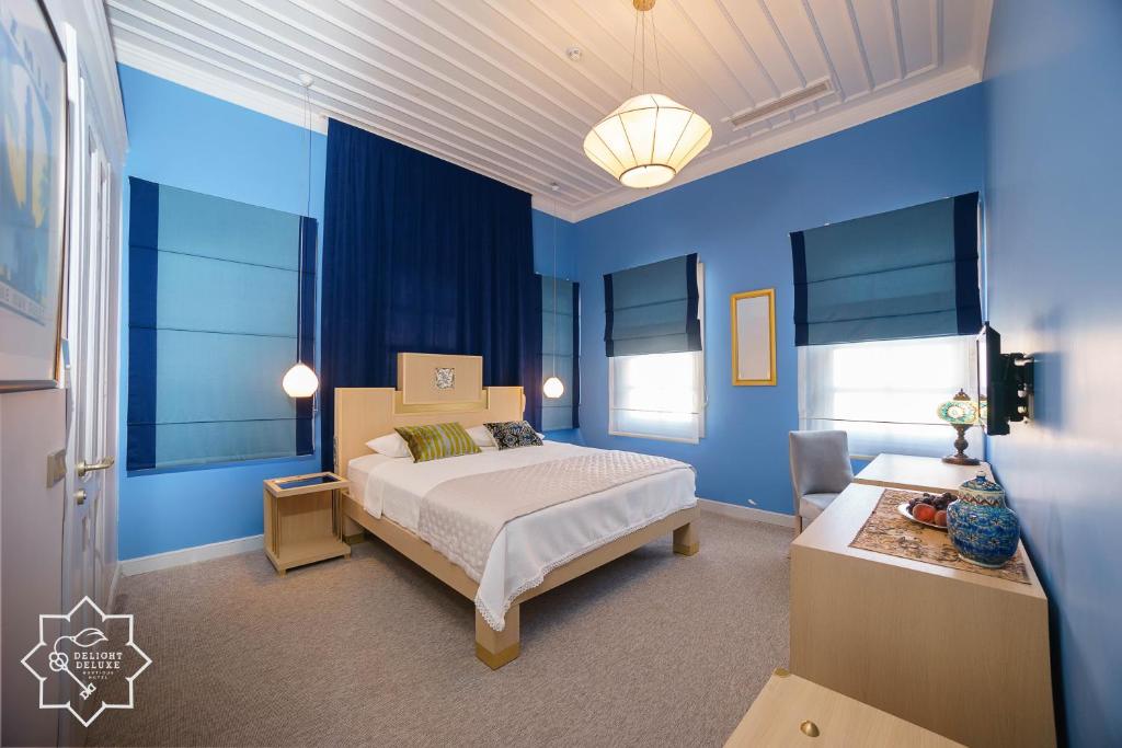 Postel nebo postele na pokoji v ubytování Delight Deluxe Hotel