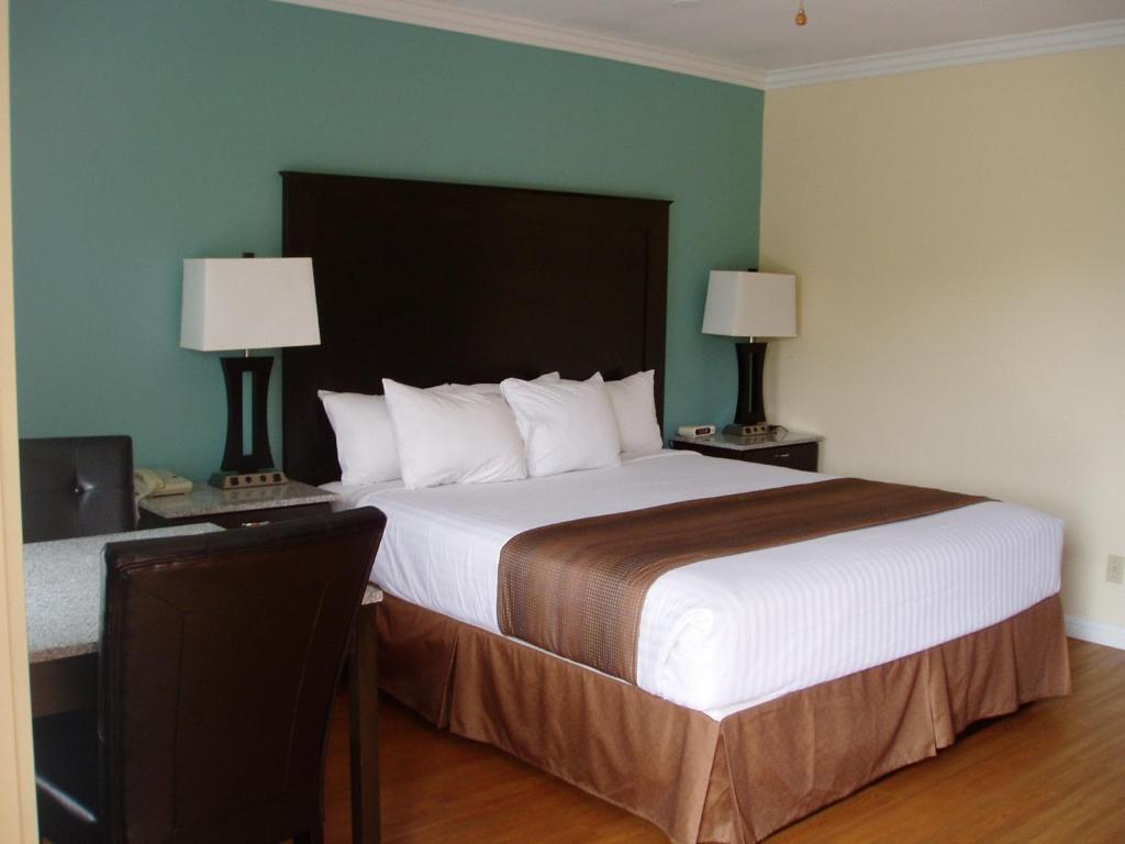 Un pat sau paturi într-o cameră la Rockview Inn and Suites