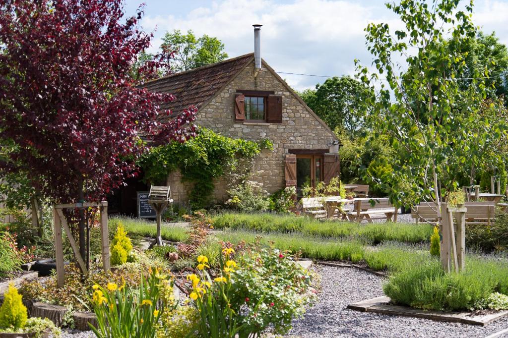 a garden in front of a stone house at Widbrook Barns in Bradford on Avon