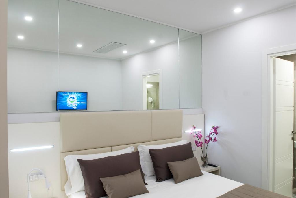 a bedroom with a large mirror above the bed at Merulana Holidays in Rome