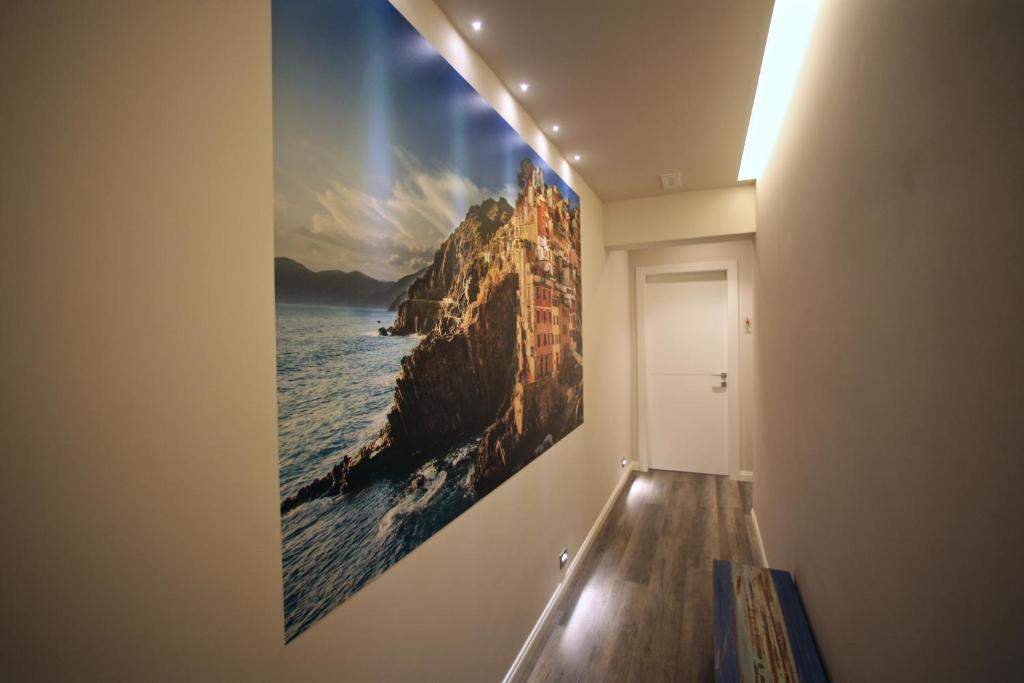 a hallway with a large painting on the wall at Echi del Mare in La Spezia