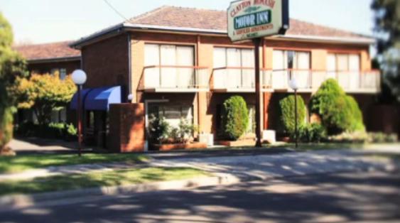 a building with a sign on the side of a street at Clayton Monash Motor Inn & Serviced Apartments in Clayton North