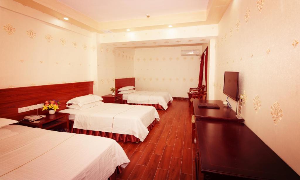 Postel nebo postele na pokoji v ubytování Guangzhou Junshan Hotel - Shuttle bus for Canton Fair