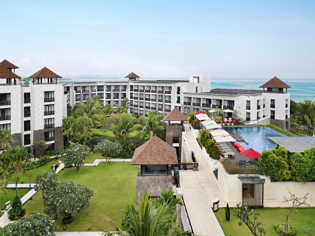 an aerial view of a resort with a swimming pool at Pullman Bali Legian Beach in Legian