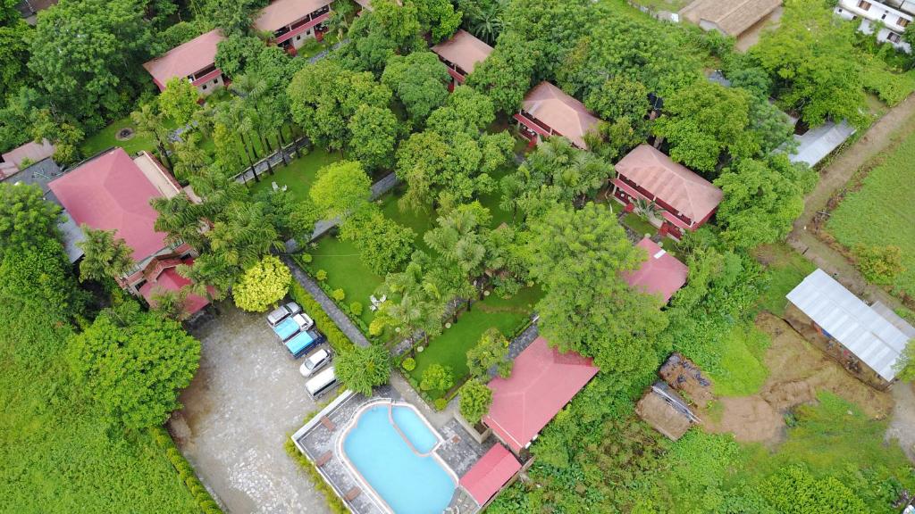an overhead view of a house with a pool and trees at Hotel Parkland in Sauraha