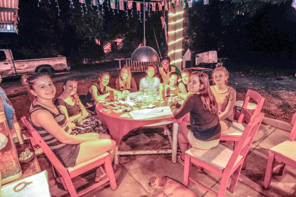 a group of girls sitting around a table at Hostal La Casa de Juan in Valle de Anton