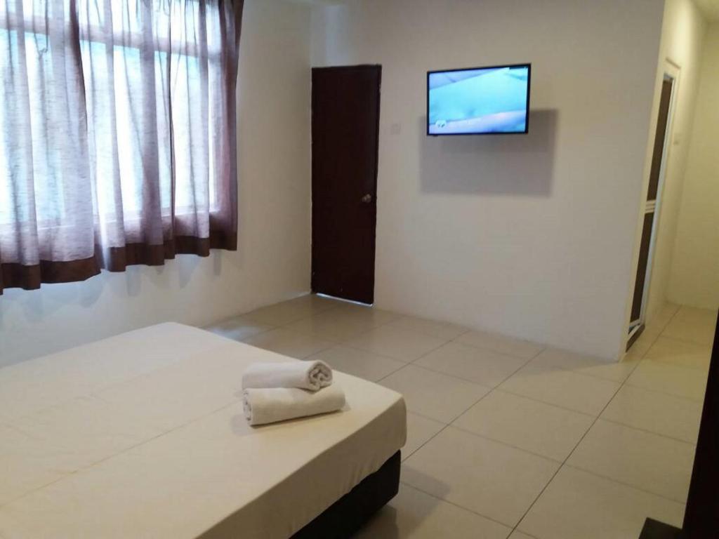 Postel nebo postele na pokoji v ubytování T-Hotel Ipoh