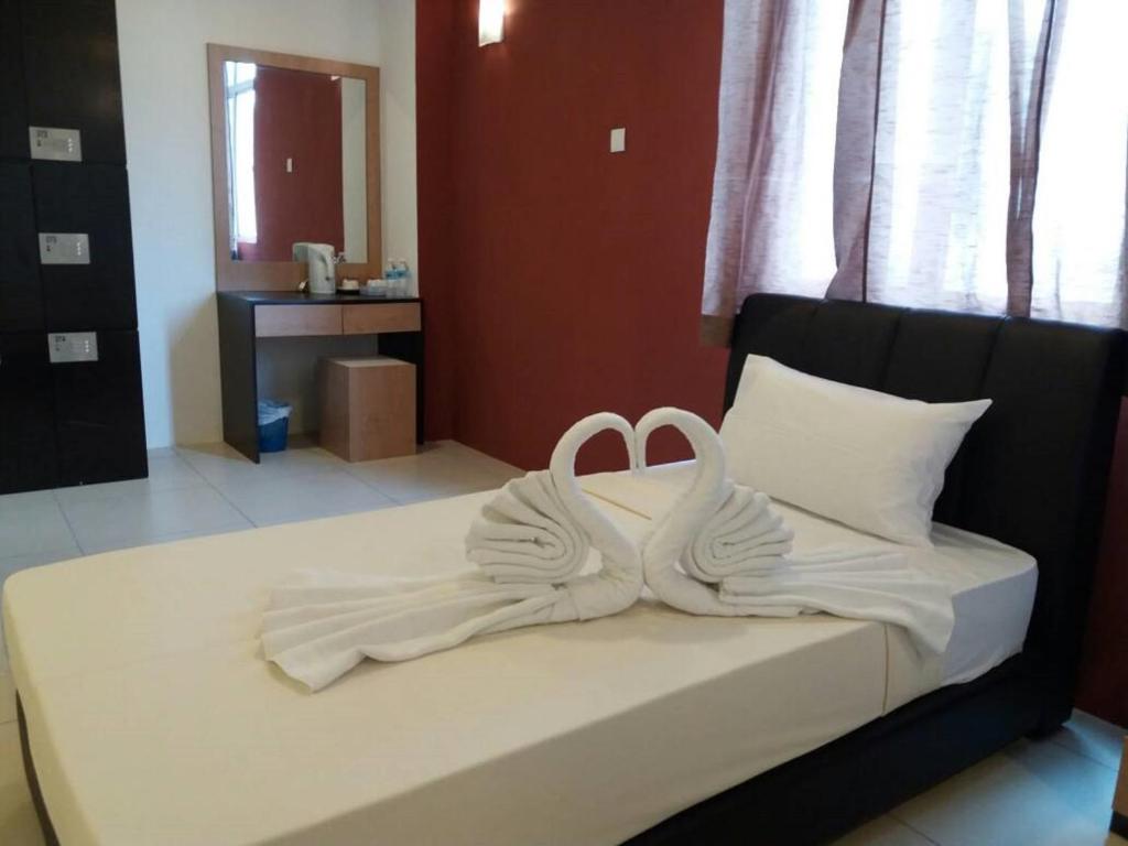 Postel nebo postele na pokoji v ubytování T-Hotel Ipoh