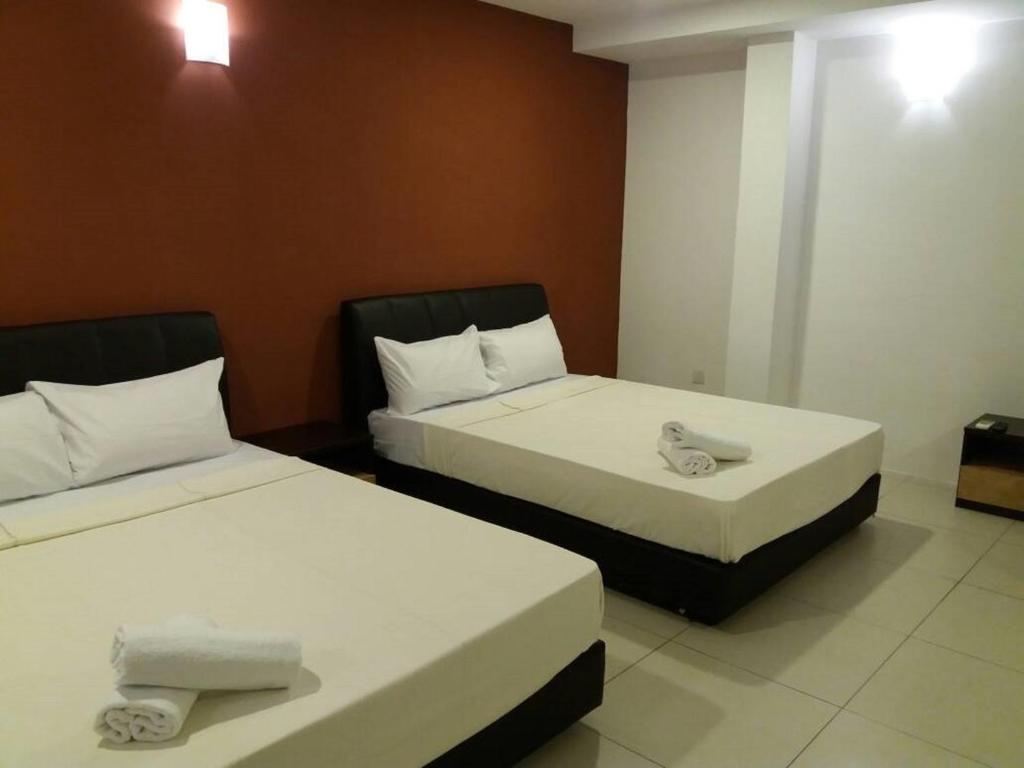 Postel nebo postele na pokoji v ubytování T-Hotel Ipoh