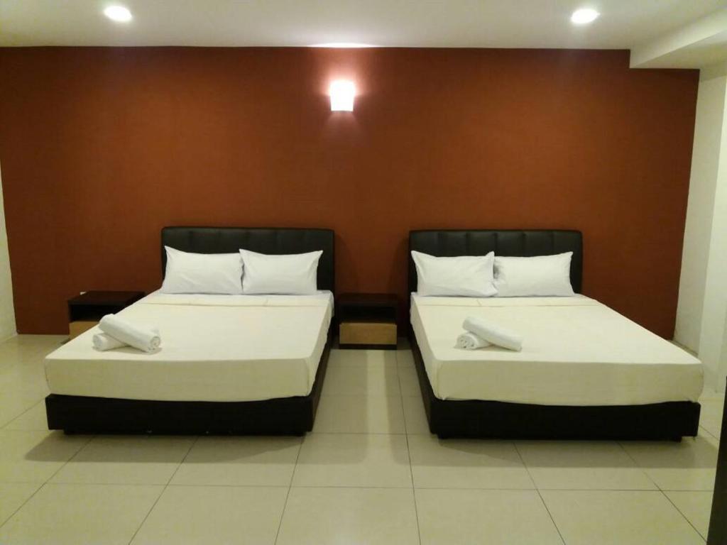 Postel nebo postele na pokoji v ubytování T-Hotel Ipoh