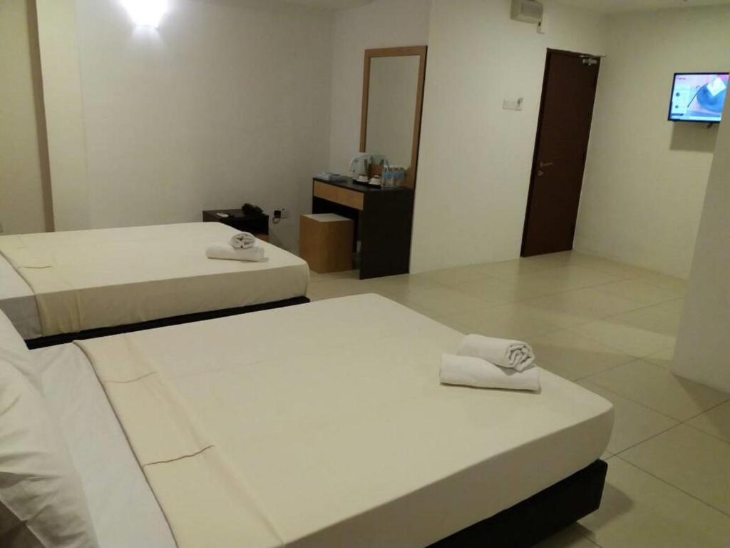 Postel nebo postele na pokoji v ubytování T-Hotel Ipoh