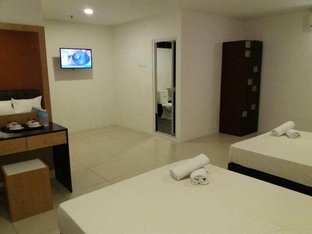 Postel nebo postele na pokoji v ubytování T-Hotel Ipoh