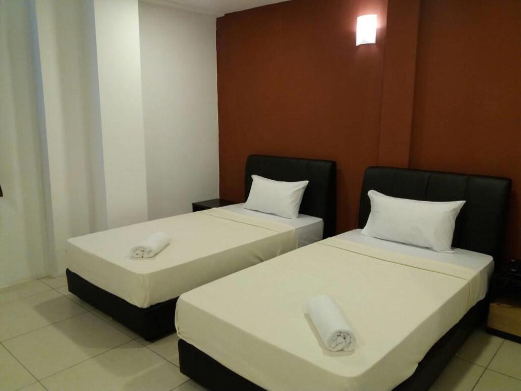 Postel nebo postele na pokoji v ubytování T-Hotel Ipoh
