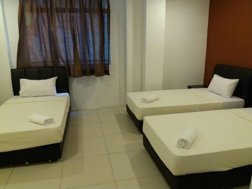 Postel nebo postele na pokoji v ubytování T-Hotel Ipoh