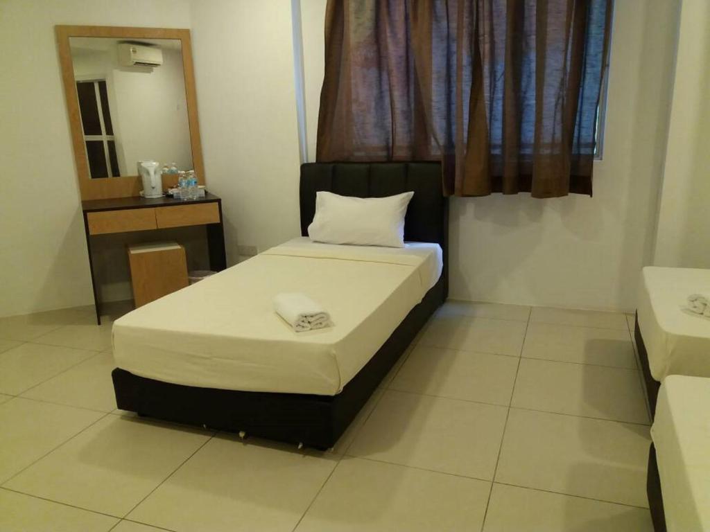 Postel nebo postele na pokoji v ubytování T-Hotel Ipoh