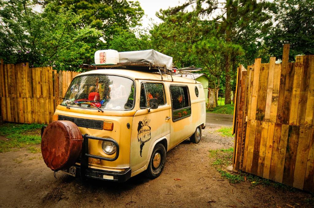a yellow van parked next to a wooden fence at Hostal La Casa de Juan in Valle de Anton