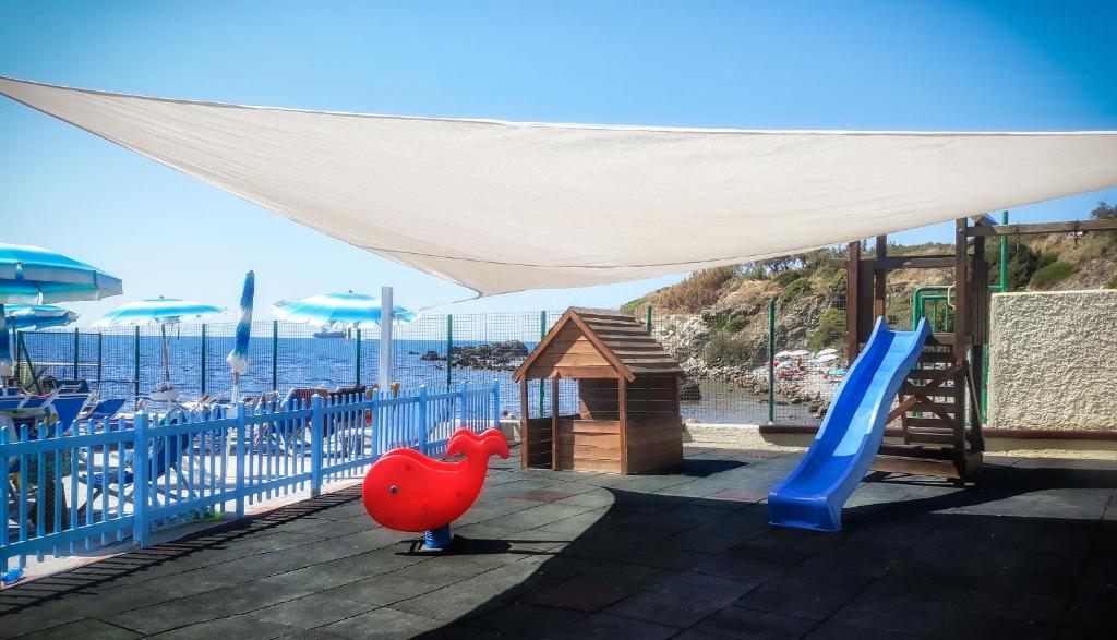 a playground with a slide and a play structure at Hotel Rex in Livorno