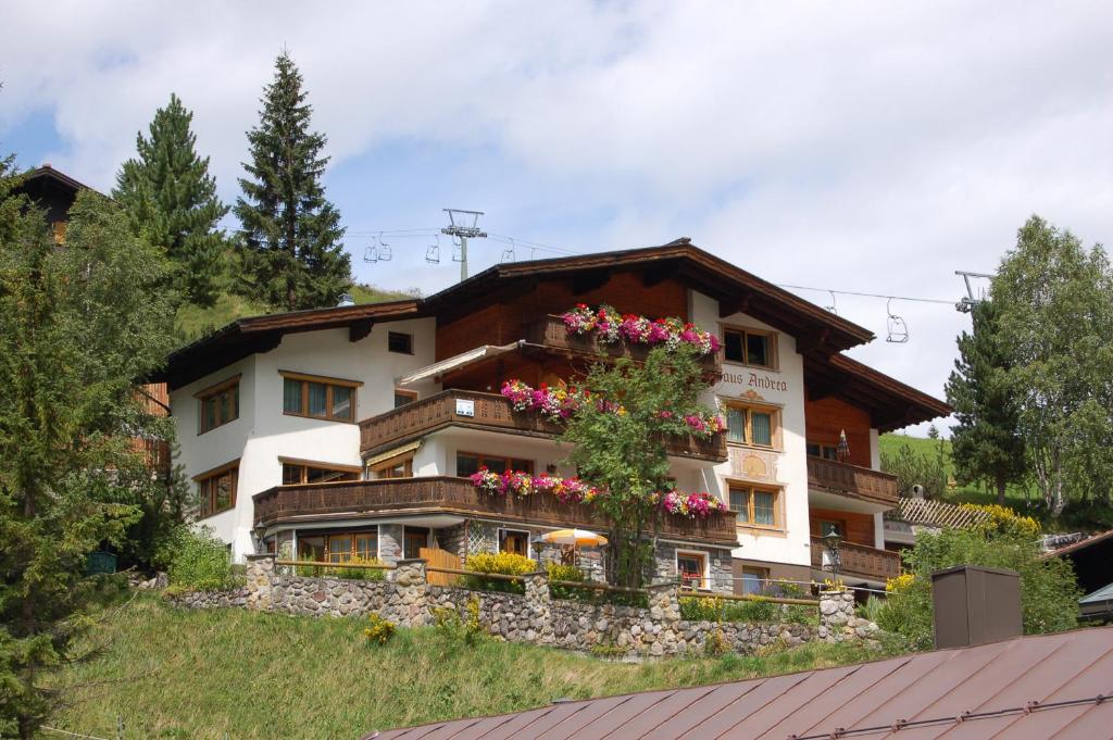 a building with flowers on the side of it at Appart Andrea in Lech am Arlberg