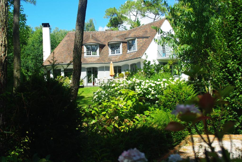 ein Haus mit Garten davor in der Unterkunft So Touquet in Le Touquet-Paris-Plage