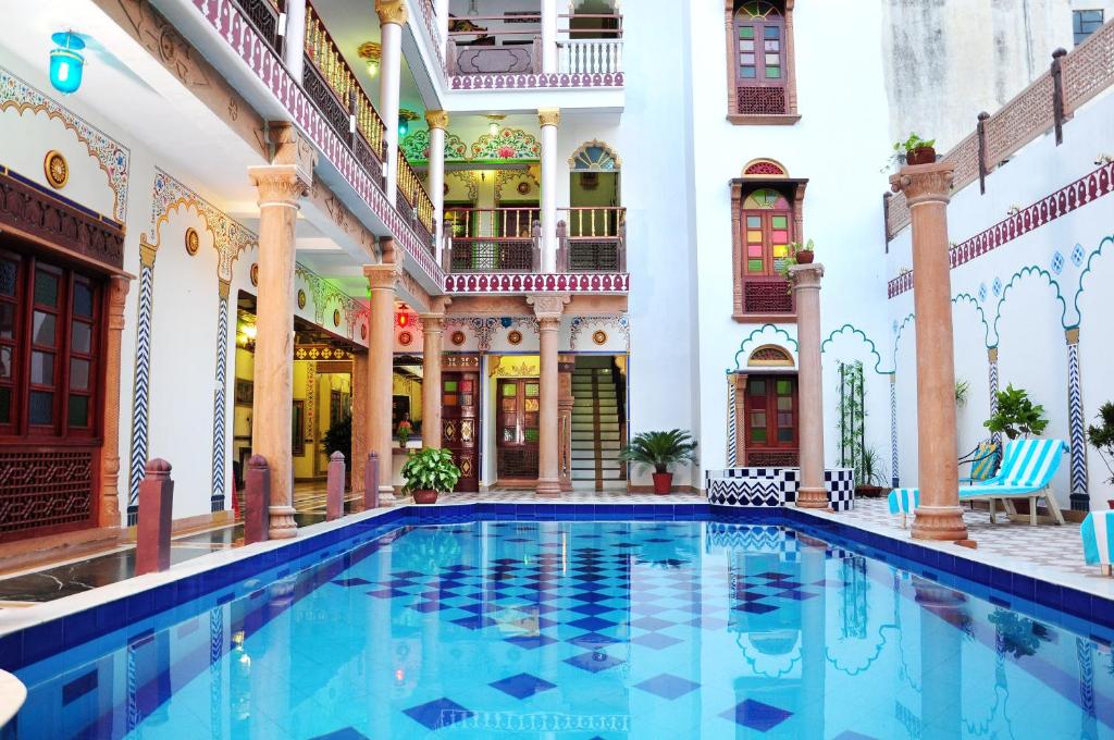 a swimming pool in the courtyard of a building at Hotel Vimal Heritage in Jaipur