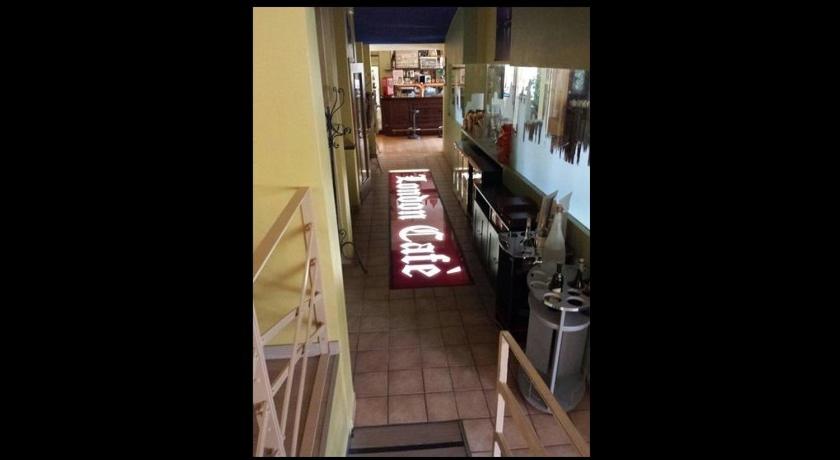 a hallway of a kitchen with a sign on the floor at London Cafè in Castelnovo neʼ Monti